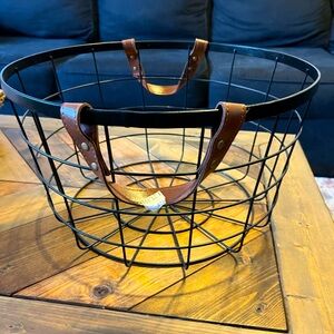 Black metal basket with brown faux leather handles. NWT